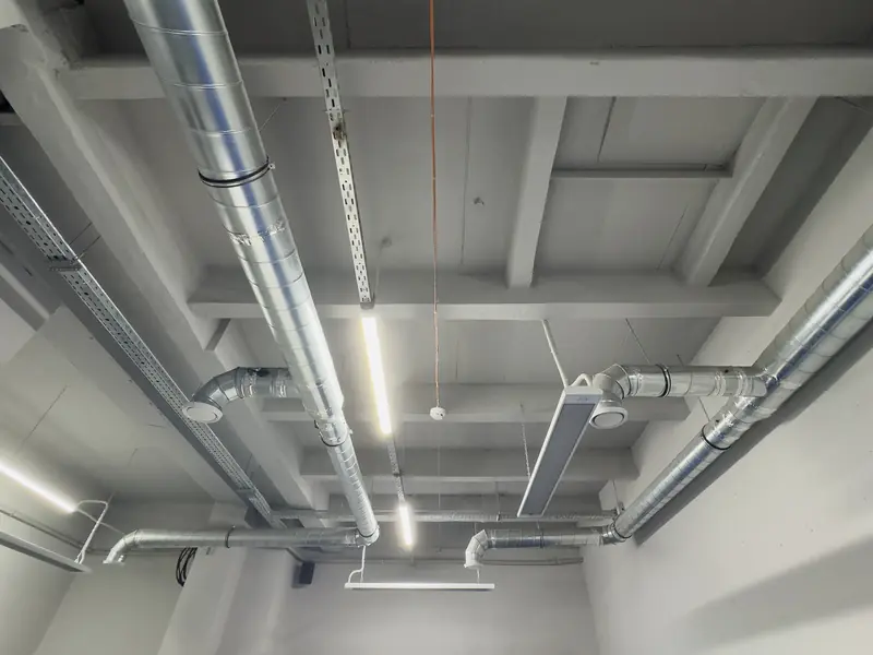 Painted basement ceiling with exposed silver ductwork and lighting left in place, Washington Township