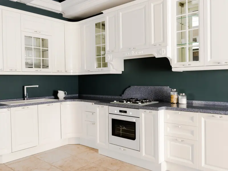 White painted kitchen cabinets with light wood accents after refinishing in Sewell