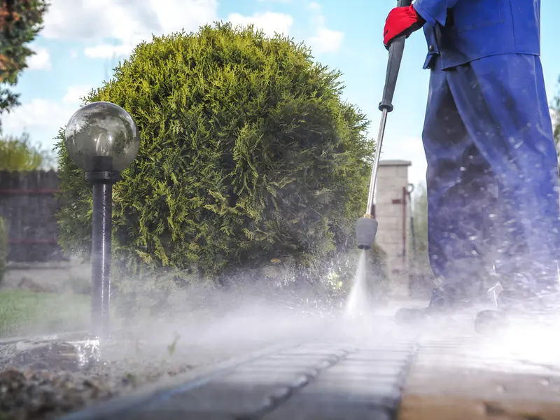Pressure washing a brick driveway and garden path in Washington Township