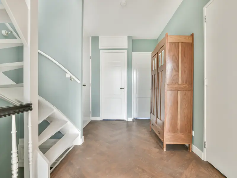 Two-story foyer and stairwell painted on staging, crisp line at the ceiling