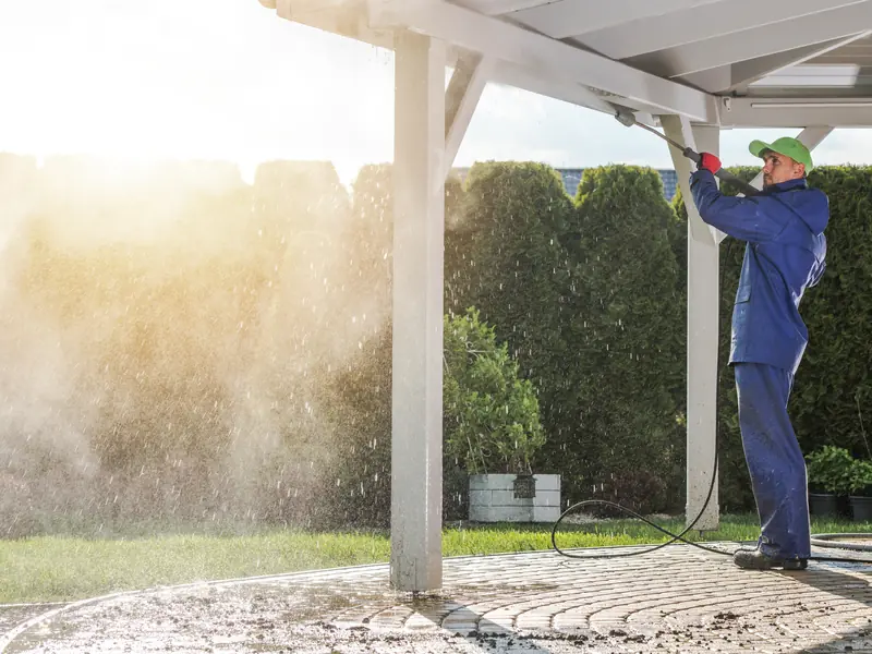 Technician cleaning the roof of a patio-side home in Turnersville